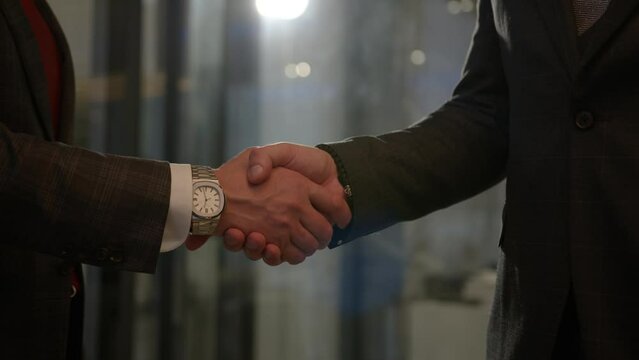 Executive managers shake hands making business deal in company office. Official partnership between innovative corporate firms