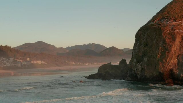 Aerial shot past haystack rock towards cannon beach