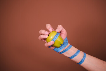 Funny student posing on a brown background. Diet and healthy lifestyle.
