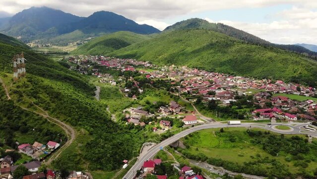 Aerial view of Garcini Sacele by Ramura Mica stream, Brasov on a sunny day