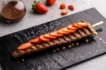 Strawberry Waffle In Stick with chocolate and caramel served in dish isolated on table top view of...