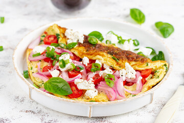 Omelette with tomatoes, feta cheese and red onion on white plate.  Frittata - italian omelet. - obrazy, fototapety, plakaty
