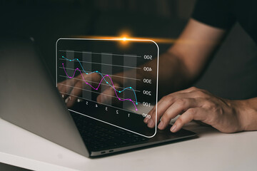 Investor analysis with stock graph on screen.