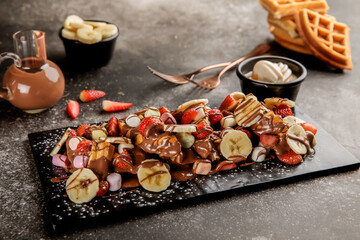 Banana, strawberry, Marshmallow Waffle with chocolate served in dish isolated on table top view of cafe waffles food dessert