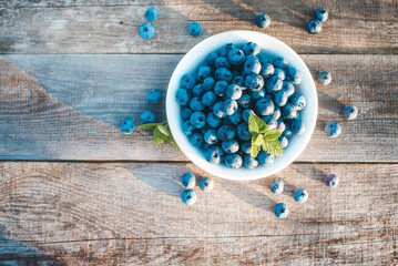 Healthy and fresh blueberry on old wooden rustic floor. Concept for healthy eating and nutrition. Top view.