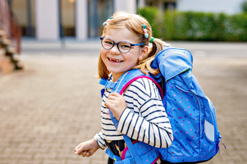 Cute little girl on her first day going to school. Healthy beautiful child walking to nursery...