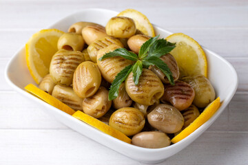 Grilled green olives. Tasty organic green olives in the plate.