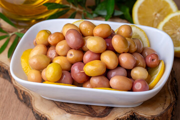 Scratched green olives. Tasty organic green olives in the plate. Olive on marble floor. Turkish name; cizik zeytin