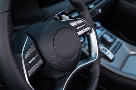  car Interior - steering wheel, shift lever and dashboard, display. Salon of a new stylish car.