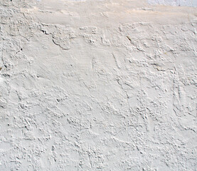 Grunge background with old stucco wall texture of beige color