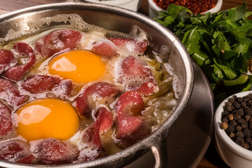 Traditional delicious Turkish bacon pastirma with eggs.