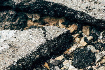 Closeup of cracked asphalt concrete road