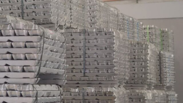 Tilt Up Shot Of Several Aluminum Ingots Properly Organized In A Warehouse