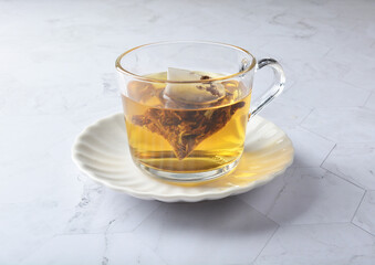 premium hot brew organic chinese green western black tea leaf bag hand pour in whisky glass pot and cup on luxury white marble table halal food beverage cafe drink menu design