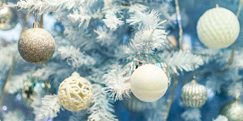 Fototapeta na wymiar Close up of Christmas tree with white ornaments.
