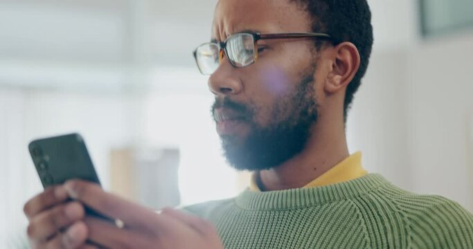 Phone, message and confused man in a living room with no reaction to fake news, phishing or scam. Smartphone, stress and male person frustrated by 404, app or problem with social media glitch at home