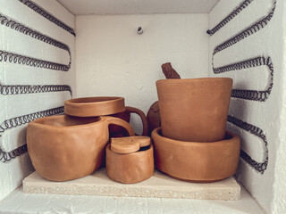Many rustic clay bowls in the kiln. Raw ceramic products without glaze, view. Crafts, hobby and lifestyle