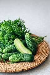Plate with cucumbers, kale, parsley and green beans, close-up.