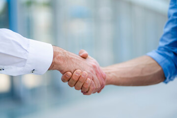 Business partners shaking hands after successful meeting