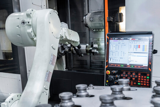 Robotic arm with cnc machinery in metal factory