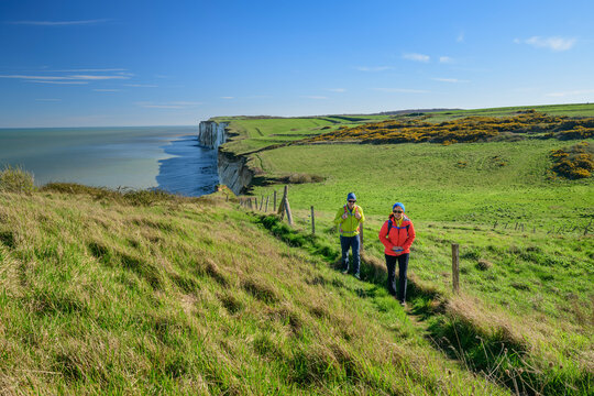 Mature couple walking on trail under sky