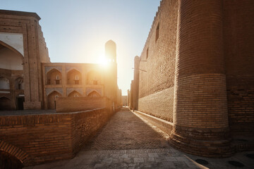 Street along which famous "Silk Road" passed among ancient buildings in Ichan-Kala fortress in historical center of Khiva. UNESCO World Heritage Site in Uzbekistan