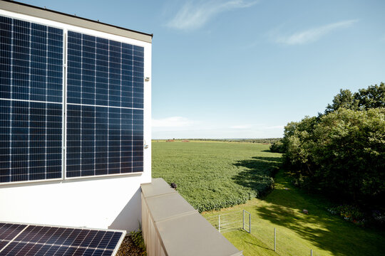 Rooftop of a privat house with a solar power station on it during a sunny day, nature on background