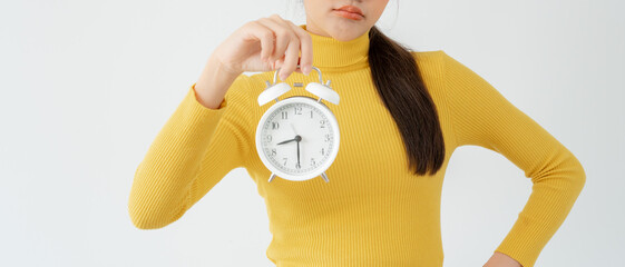 Stress Asia young woman show clock alarm, lady is late appointment or work or class study,...