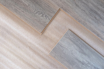 Installing laminated floor, detail on wooden tiles ready to be fit