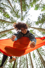 happy woman on hammock in the forest