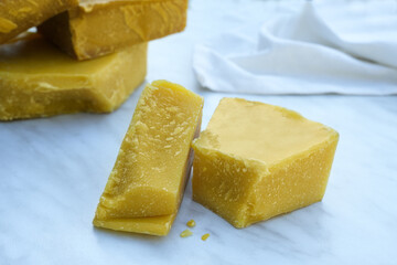 Pieces of organic beeswax. The use of beeswax in apitherapy. Production ingredient for medical and cosmetics. Side view.
