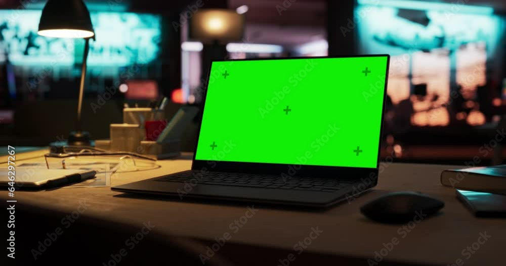 Poster Zoom Out Shot of Laptop Computer Standing on a Wooden Desk with a Green Screen Chromakey Mock Up Display. Creative Office Working Station for Game Developer and Graphic Designer in Creative Agency