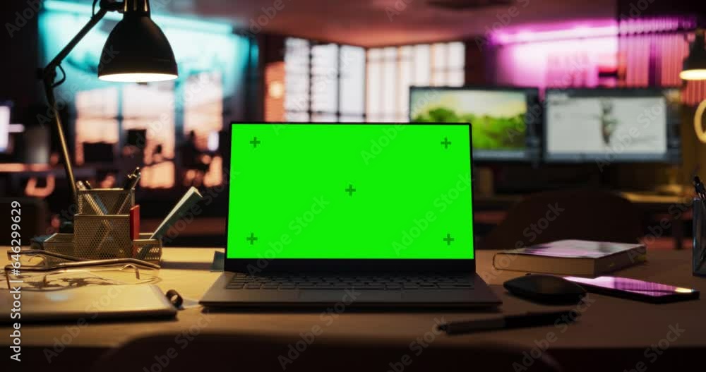 Fototapete Zoom in Shot of Laptop Computer Standing on a Wooden Desk with a Green Screen Chromakey Mock Up Display. Creative Office Working Station for Game Developer and Graphic Designer in Creative Agency