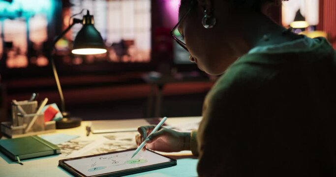 Portrait of Young Black Female Using Technology and Visualising to Brainstorm for the New Marketing Strategy. Entrepreneur Mind Mapping on a Digital Tablet in Creative Office at Night