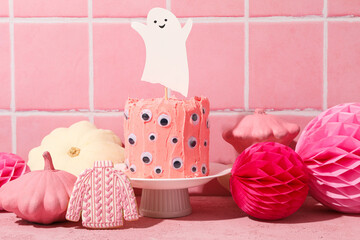 Fototapeta na wymiar Festive pink cake with a ghost for Halloween