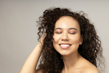 An attractive girl takes care of her facial skin