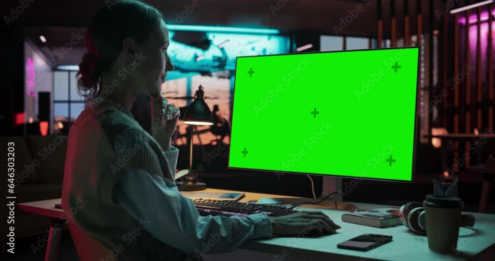 Poster Zoom in Over the Shoulder: Female Caucasian Specialist Working on Computer with Chroma Key Display at Creative Agency. Young Woman Sitting at Her Desk Using Desktop Computer with Mock-up Green Screen