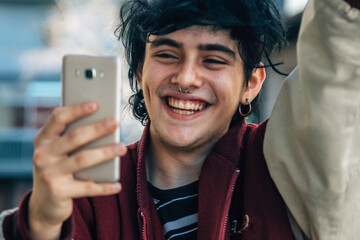 teenager looking at the phone with expression of victory or success