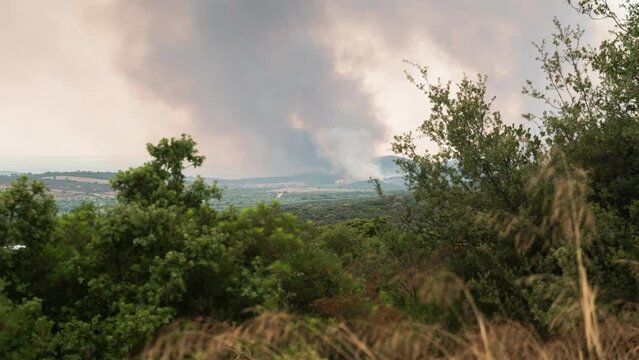 Wildfire Timelapse Smoke Large Brush Fire wide Shot pan right Greece Summer