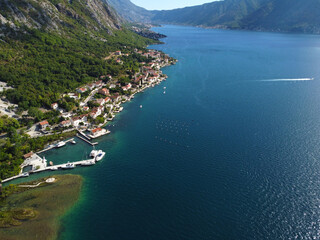 Fototapeta premium Aerial drone high view of Kotor bay, Boka Kotorska and coastal town Kotor, Cattaro, in Montenegro. Location place famous resort Montenegro. Adriatic fjord surrounded by rugged mountains