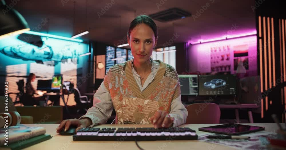 Poster Zoom Out Portrait of a Young Woman Typing on Keyboard and Working on Desktop Computer in a Creative Office with Neon Lights. Female Software Developer Writing Code. Point of View of Screen Monitor