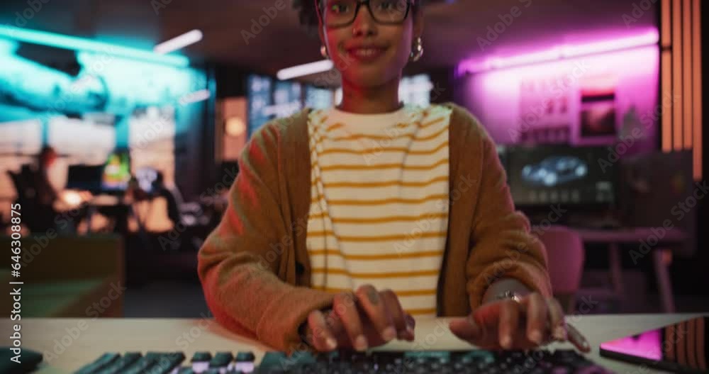 Poster pov from monitor screen: motivated black female using desktop computer in creative agency in evening