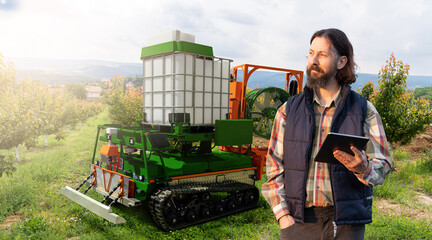 Autonomous robot sprayer works in a fruit garden. Smart farming concept