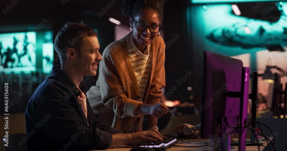Leinwandbilder two stylish diverse employees discussing design on computer in game development company. portrait of