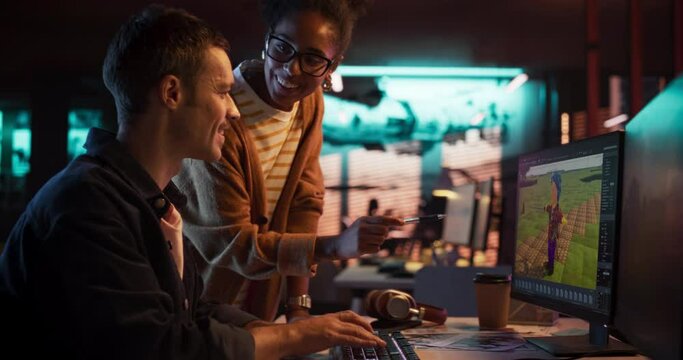 Portrait of Black Creative Director and Male Developer Talking About Work in Creative Agency. Two Stylish Diverse Employees Discussing Character Design on Computer in Game Development Company