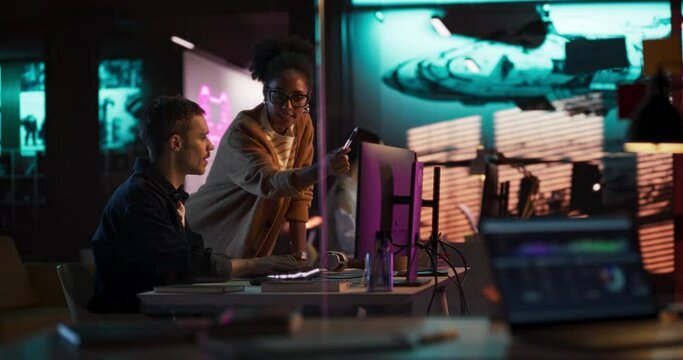 Portrait of Black Creative Director and Male Developer Talking About Work in Creative Agency. Two Stylish Diverse Employees Discussing Character Design on Computer in Game Development Company