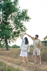Fototapeta premium Playful and youthful adult man and woman having fun together in the meadow.