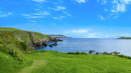 Scotland Shetland scenery in England with cliffs, ocean views and green pastures.