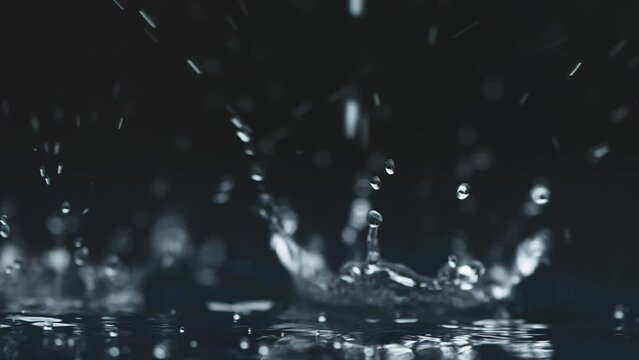 rain background. water droplets, splashes on a black background. slow motion