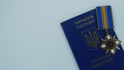 
Ukrainian passport with a medal for courage on a white background. Ukrainian citizenship with a...